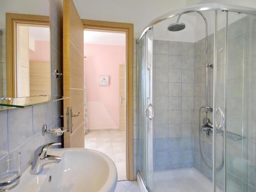 a bathroom with a sink and a shower at Villa Alexandros in Spartià