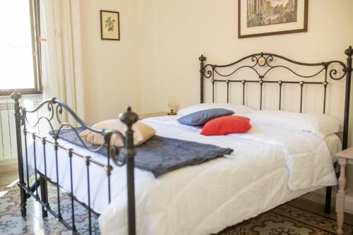 a bedroom with a bed with two pillows on it at IL PALAZZO - Luxury Home & Event in Cosenza