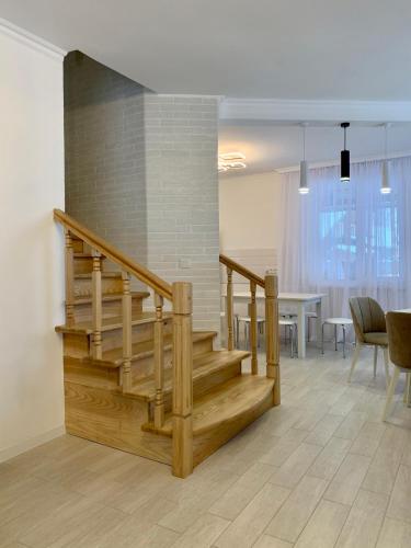 uma escada num quarto com uma mesa e cadeiras em Котедж Макс em Slavske