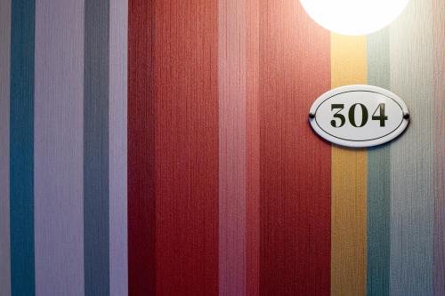 a door with a speed limit sign on a striped wall at FLÜHLI Hotel Kurhaus in Flühli