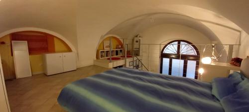 a bedroom with a bed in a room with arches at Ars Amandi in Sulmona