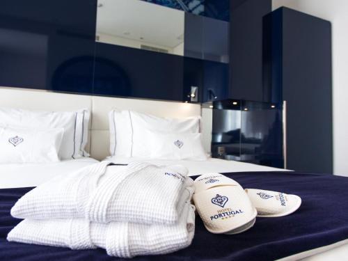a bed with two baseball mitts on top of it at Portugal Boutique Hotel in Lisbon