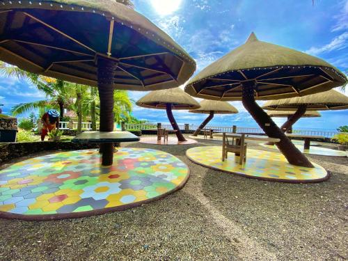 a group of umbrellas on the ground near the beach at Azure Camotes Resort Hotel in Camotes Islands