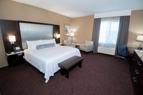 a large hotel room with a bed and a chair at Win-River Resort and Casino in Redding