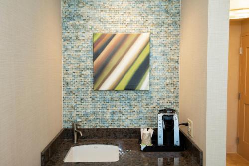 a bathroom with a sink and a painting on the wall at Win-River Resort and Casino in Redding