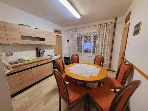 a kitchen with a table and chairs in a room at Chalupa Hutisko in Hutisko
