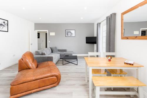 a living room with a couch and a table at Marvel Apartments Leamington Spa in Leamington Spa
