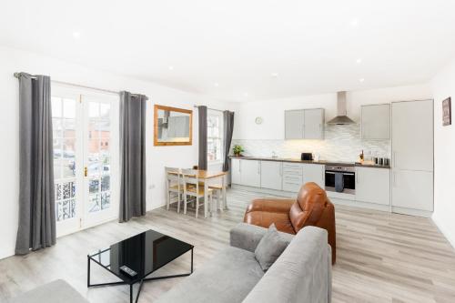 a living room with a couch and a table at Marvel Apartments Leamington Spa in Leamington Spa