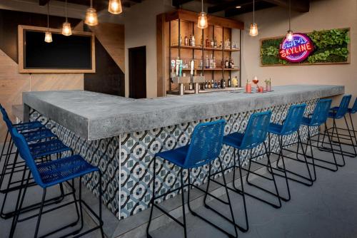 a bar with blue chairs in a restaurant at Holiday Inn Express Hotel & Suites Austin Downtown, an IHG Hotel in Austin