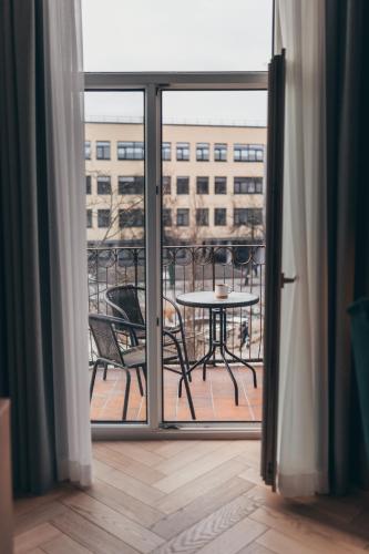 a view from a balcony with a table and chairs at Lindens apartments with AC and view to central square in Panevėžys