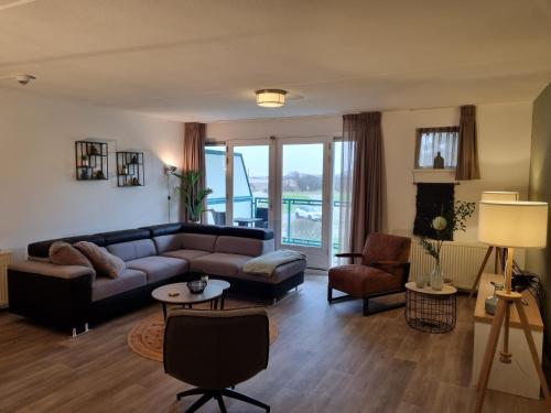 a living room with a couch and a table at Beach appartement Strandslag 129 in Julianadorp