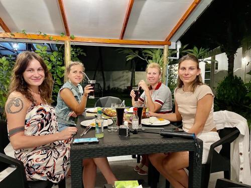 a group of women sitting at a table drinking wine at Thoddoo Island Life in Thoddoo