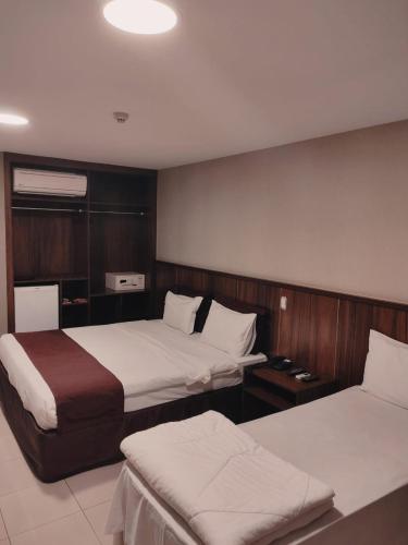 a hotel room with two beds at Esplanada Brasilia Hotel e Eventos in Brasília