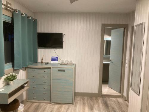 a room with a dresser with a tv on the wall at Villa Palma in Marbella