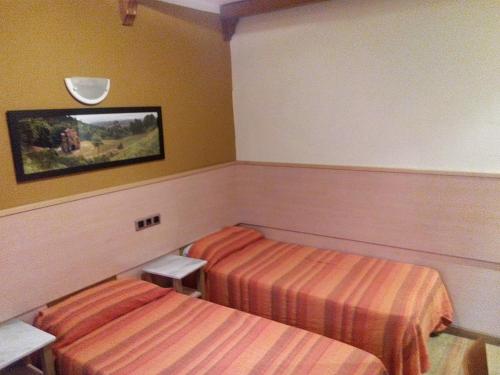 a hotel room with two beds in a room at ALBOR II in Gijón