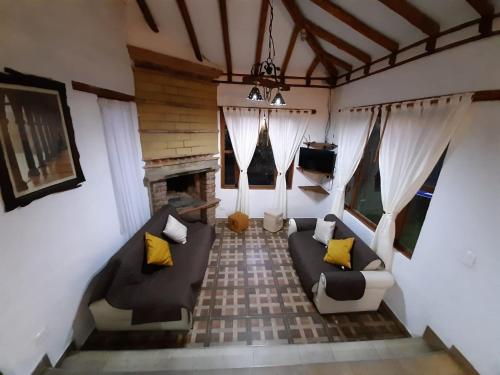 a living room with a couch and a fireplace at Caba-glamping La Fortuna de Luna in Villa de Leyva