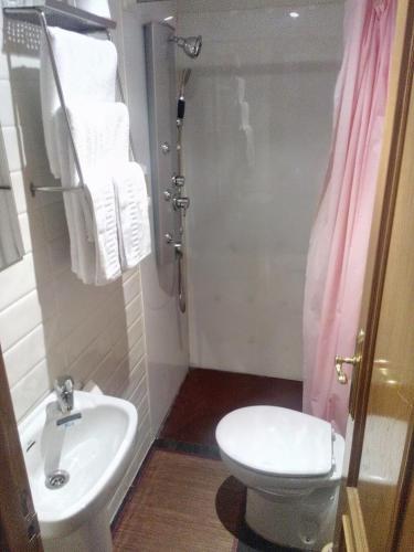 a bathroom with a sink and a toilet and towels at ALBOR II in Gijón