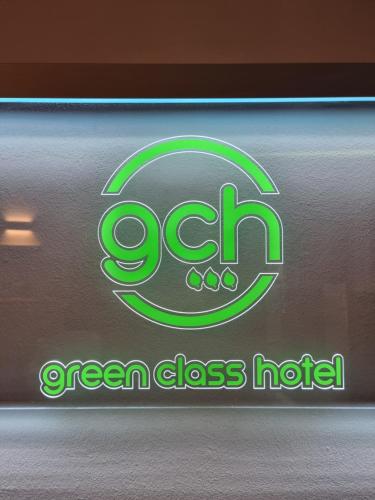 a green glass holder with a green glass label at Green Class Hotel Astoria in Turin