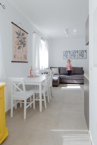 a living room with a white table and a couch at Ivino in Omiš