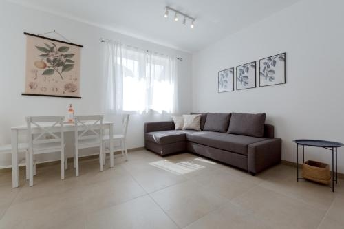 a living room with a couch and a table at Ivino in Omiš