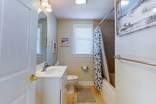 a bathroom with a sink and a toilet and a shower at Mahalo 402 in Ocean City