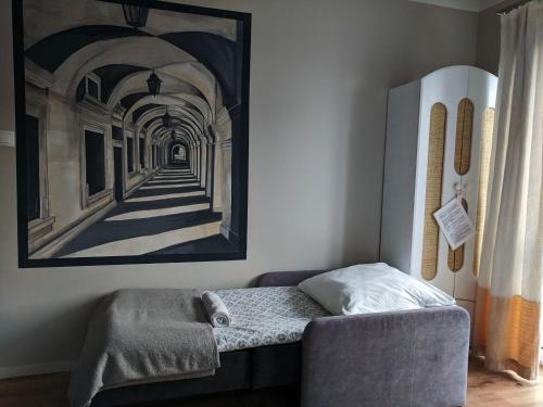 a living room with a couch and a painting on the wall at APARTAMENT 16 in Zamość