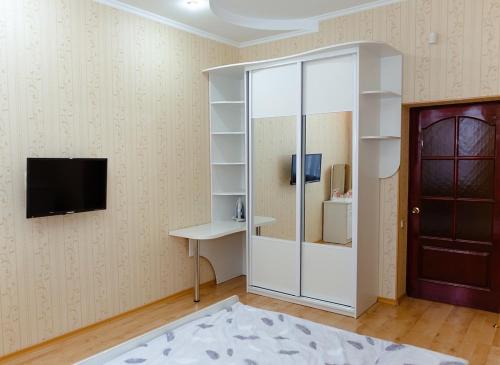 a room with a sliding glass door and a tv at Leninskaya Apartments in Mogilev