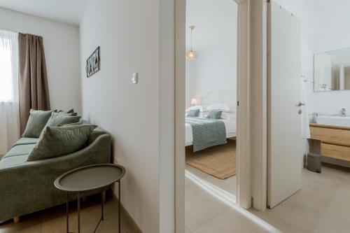 a living room with a couch and a bedroom at Ivino in Omiš