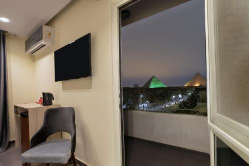 a room with a window with a view of a city at Brothers Pyramids View in Cairo
