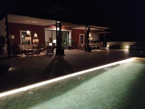 a swimming pool in a house at night at Agroturismo Bini Aumaia in Es Mercadal