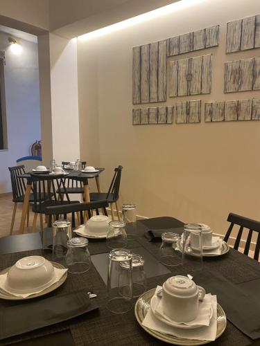 a table with plates and dishes on top of it at Elanthi Village Apartments in Kalamaki