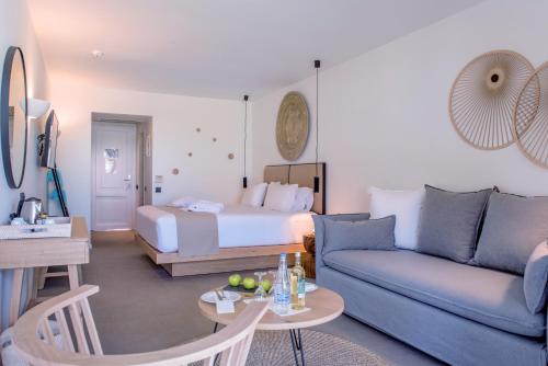 a living room with a bed and a couch at Blue Sea Beach Affiliated By Melia in Stalida