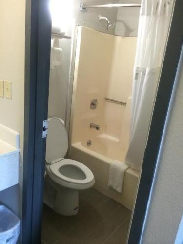 a bathroom with a toilet and a tub and a shower at Lotus Inn and Suites Nashville in Nashville