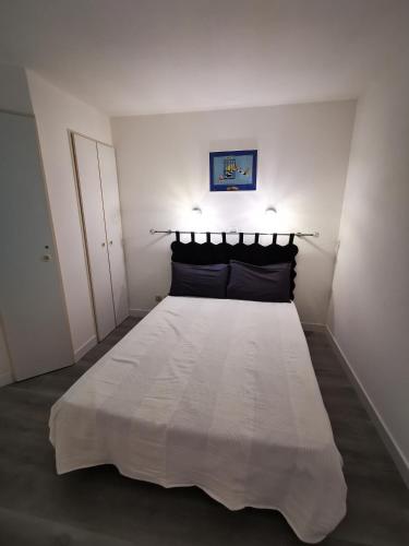 - une chambre blanche avec un grand lit blanc dans l'établissement Appartement en bord de mer, à Cannes