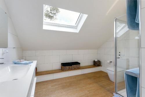 a bathroom with a sink and a toilet and a window at The Farm Willunga in Willunga