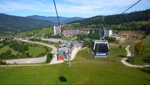 a gondola ride up a hill in a green field at STUDIO LES GLOVETTES in Villard-de-Lans