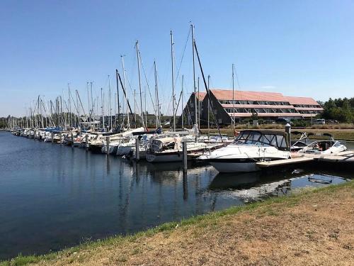 a group of boats docked in a marina at IJsvogel Apartment, Duplex Family Home 4-bed located on the largest saltwater lake in Bruinisse