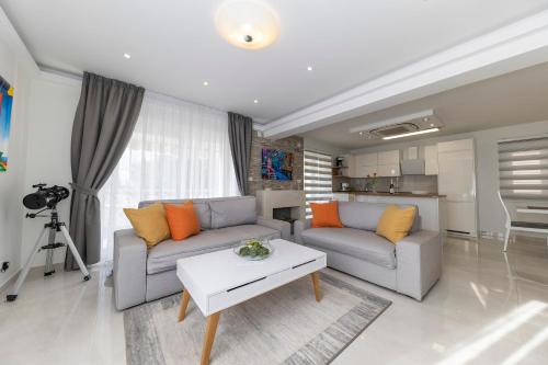 a living room with two couches and a table at JOY 1 apartment in Novalja