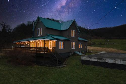 a house at night with a starry sky at The Olde Homestead with Mtn Views Near Coudersport in Coudersport