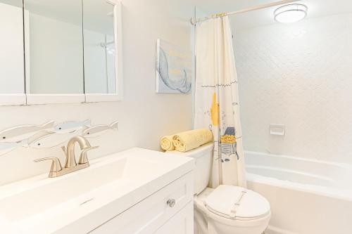 a white bathroom with a toilet and a bath tub at Mariner II 4N in Ocean City