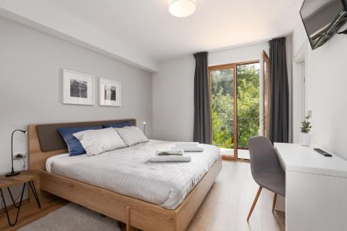 a bedroom with a large bed and a window at Vitis Apartment Istra in Tinjan