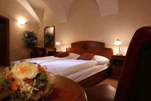 a hotel room with two beds and a table at Kastiel Lucivna in Lučivná