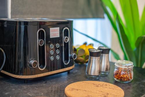 a black toaster sitting on top of a counter at The Blossoms Studio Apartments in Liverpool
