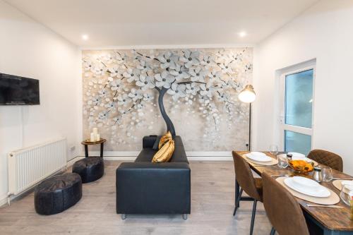 a living room with a couch and a table at The Blossoms Studio Apartments in Liverpool