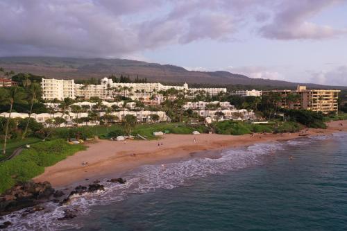 an aerial view of a beach with hotels and buildings at Fairmont Kea Lani, Maui in Wailea