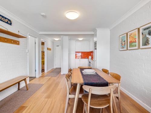 a dining room with a table and chairs at Astrids at Central Park - 2BR l Lake & Mountain Views l Central Location l WiFi in Jindabyne