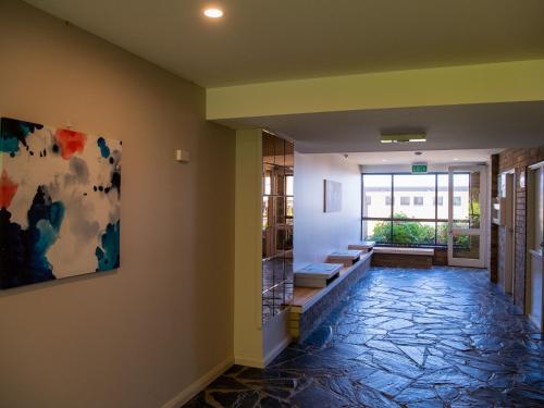 a hallway with a painting on the wall at Astrids at Central Park - 2BR l Lake & Mountain Views l Central Location l WiFi in Jindabyne