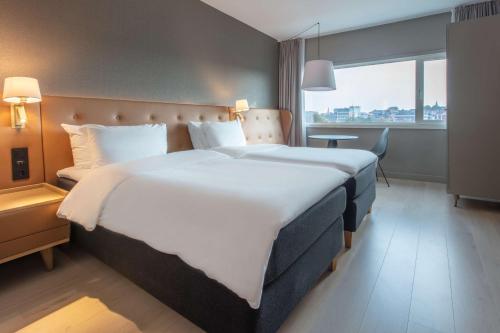 a hotel room with a large bed and a window at Radisson Blu Atlantic Hotel, Stavanger in Stavanger