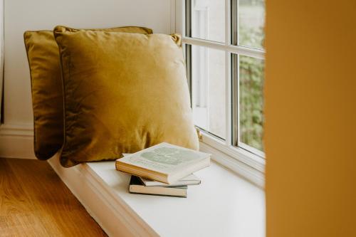 a book and two books on a window sill at Abbeyview House B&B and Glamping in Abbeyshrule