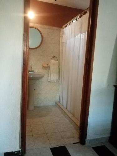 a bathroom with a shower and a sink and a mirror at Caribbean Paradise in Cancún